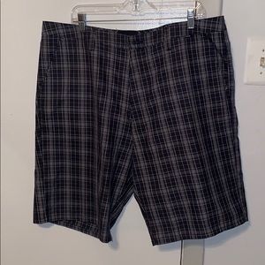 Hurley back and grey plaid shorts.